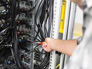 Technician working on a server rack